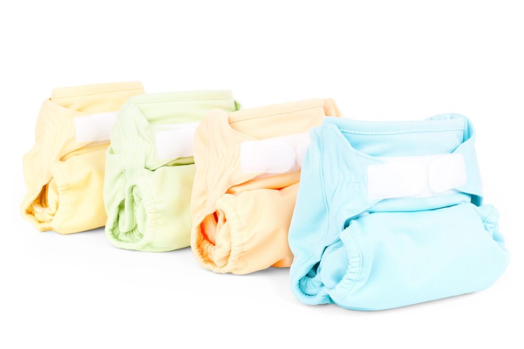 Colorful cloth diapers lined up against a white background.