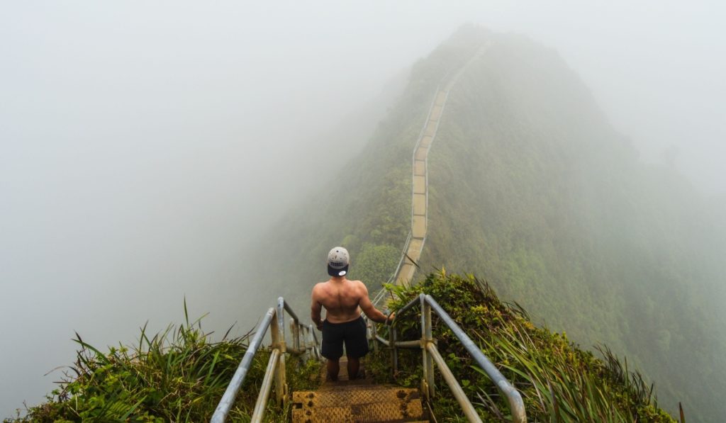 Honolulu, Hawaii - August 2nd 2017: Fit man walking on Stairway to heaven in Hawaii, Haiku Stairs Trail, Oahu Island, USA