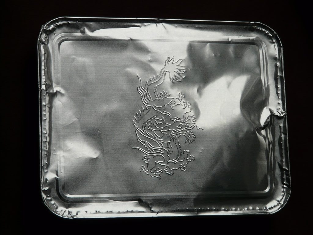 A piece of aluminum foil with a dragon printed on it. 