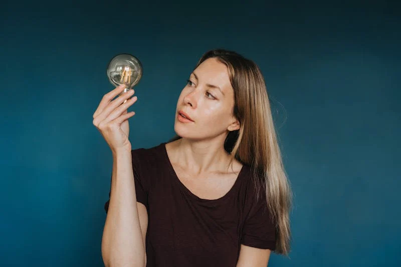 Woman holding a lightbulb
