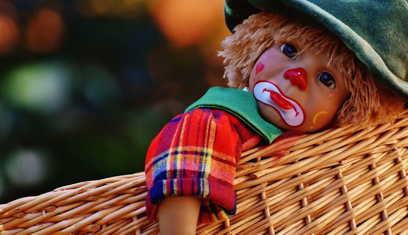 sad clown in wicker basket