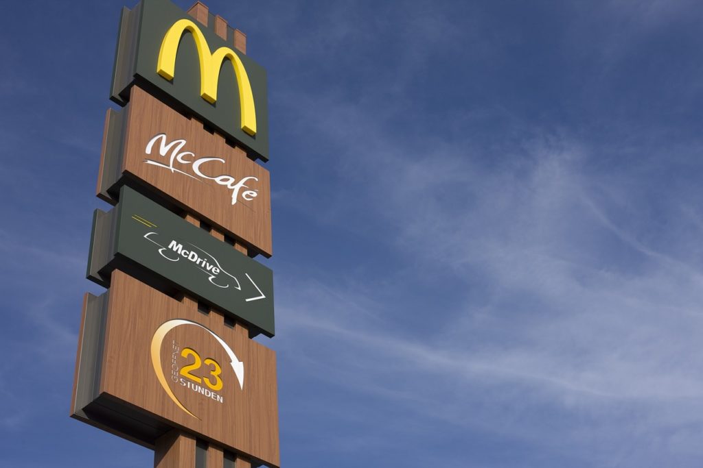 Several McDonald's signs. Blue sky in the background.