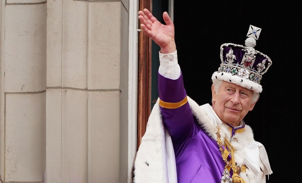 King Charles III steps out, waves from Buckingham Palace after coronation on May 06, 2023, London, England.