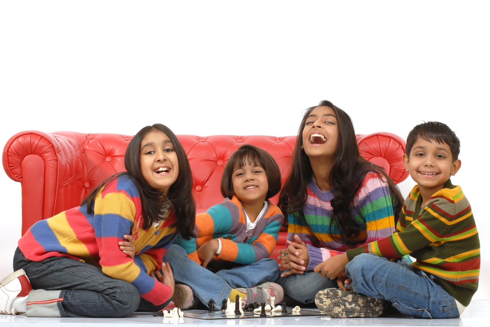 indian children playing board game at home