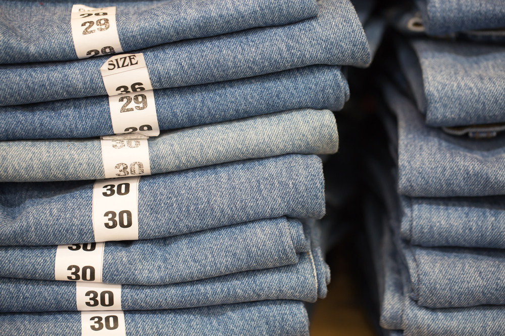 Blue jeans denim Collection jeans stacked with lable size.