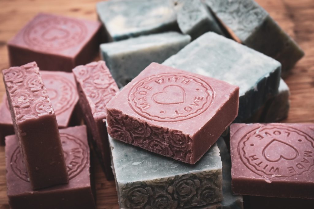 Multicolored soap with a wooden background.