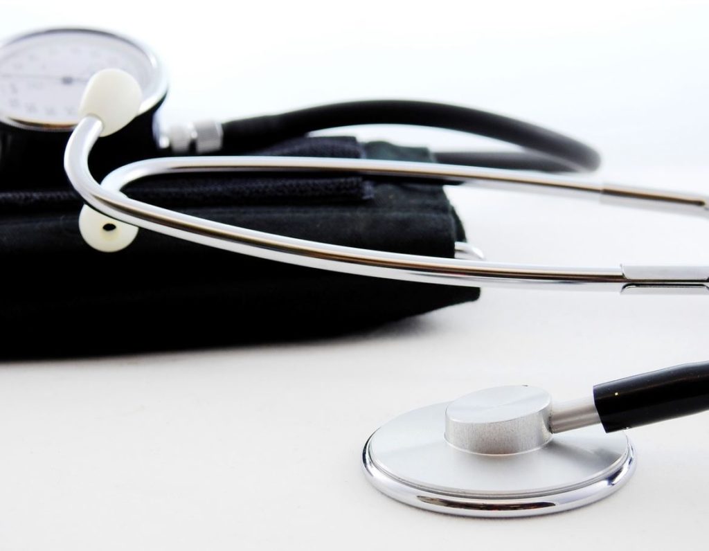 Stethoscope with a black bag and white background. 