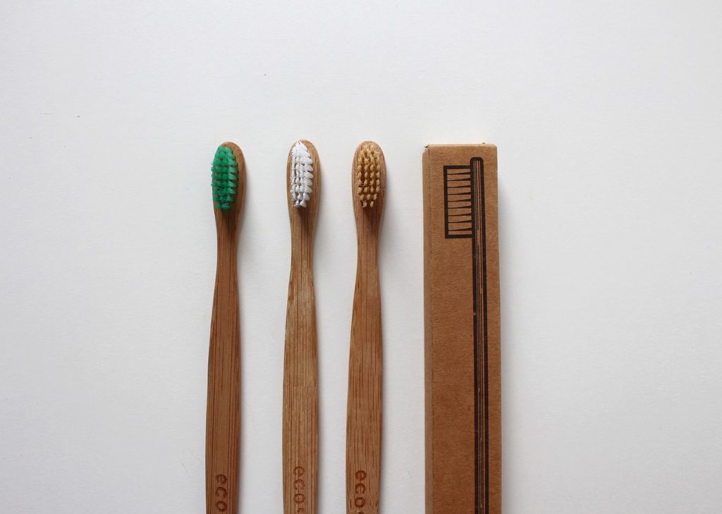 Ecofriendly bamboo or other wood material toothbrushes against a white background.