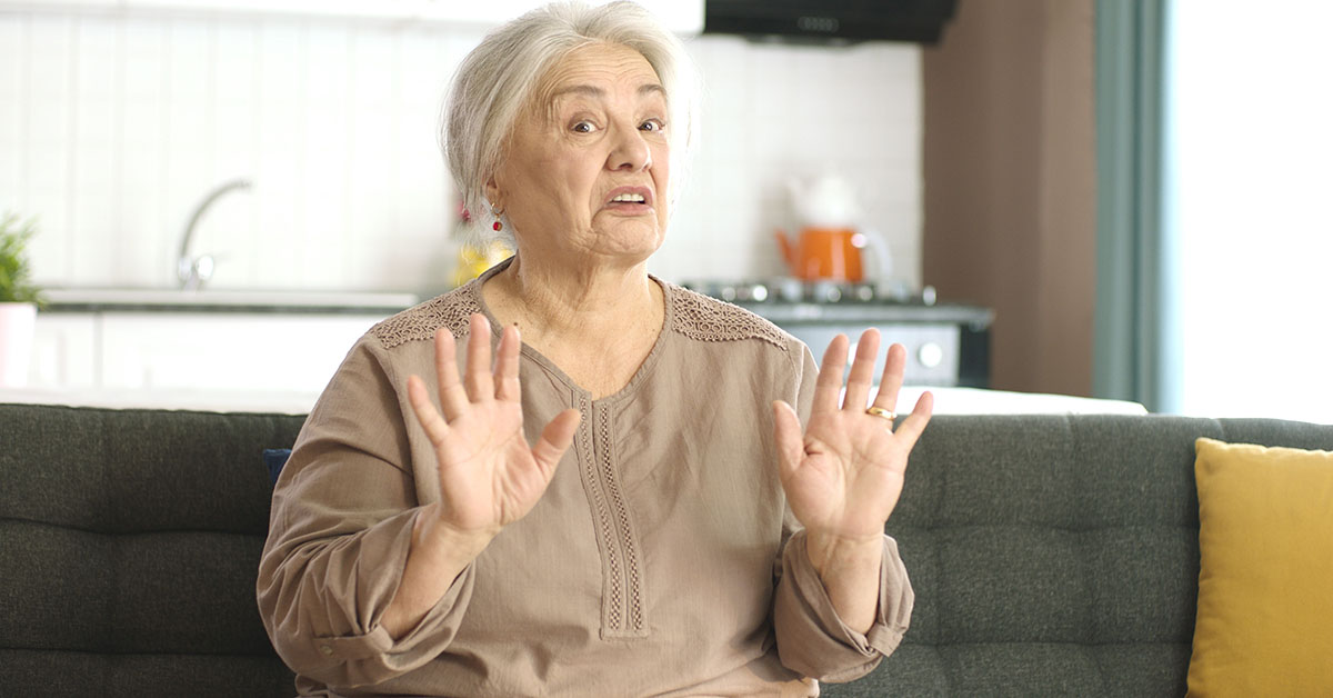 elderly woman putting hands up
