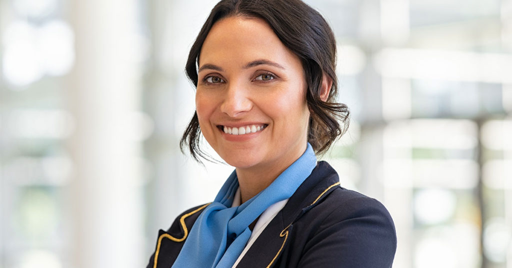 Flight Attendant Reveals Scary Reason Why Passengers Should Never Wear T-Shirts On a Flight - Featured image