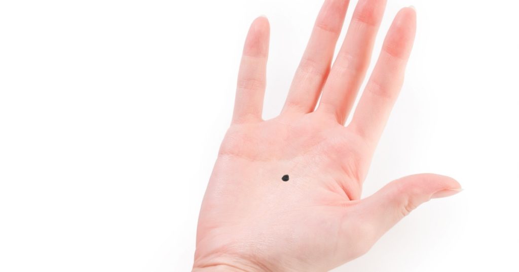 woman hand with black dot isolated on white with clipping path