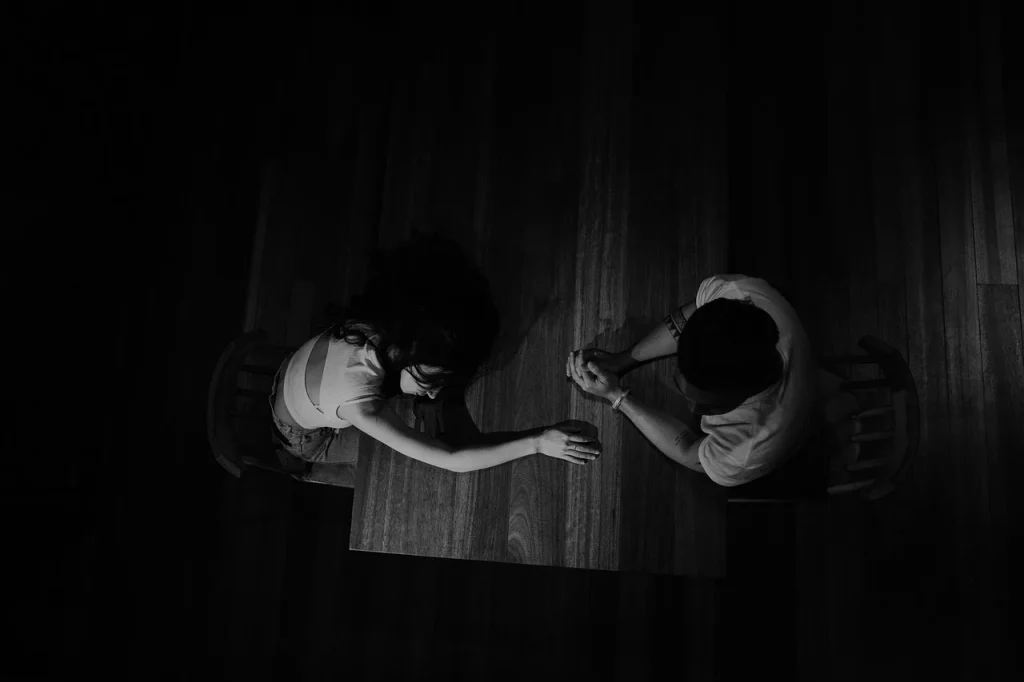 An aerial view of a black and white image of a man and woman sitting at a table.