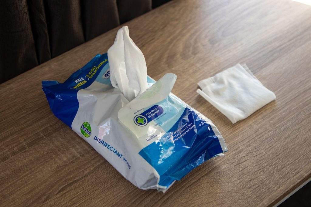 A package of sanitizing wipes. Wood in the background.