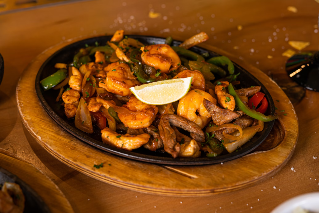 birthday party etiquette - The allure of fajitas lies in their presentation – a sizzling plate accompanied by an array of wraps, salsas, guacamole, sour cream, and cheese.