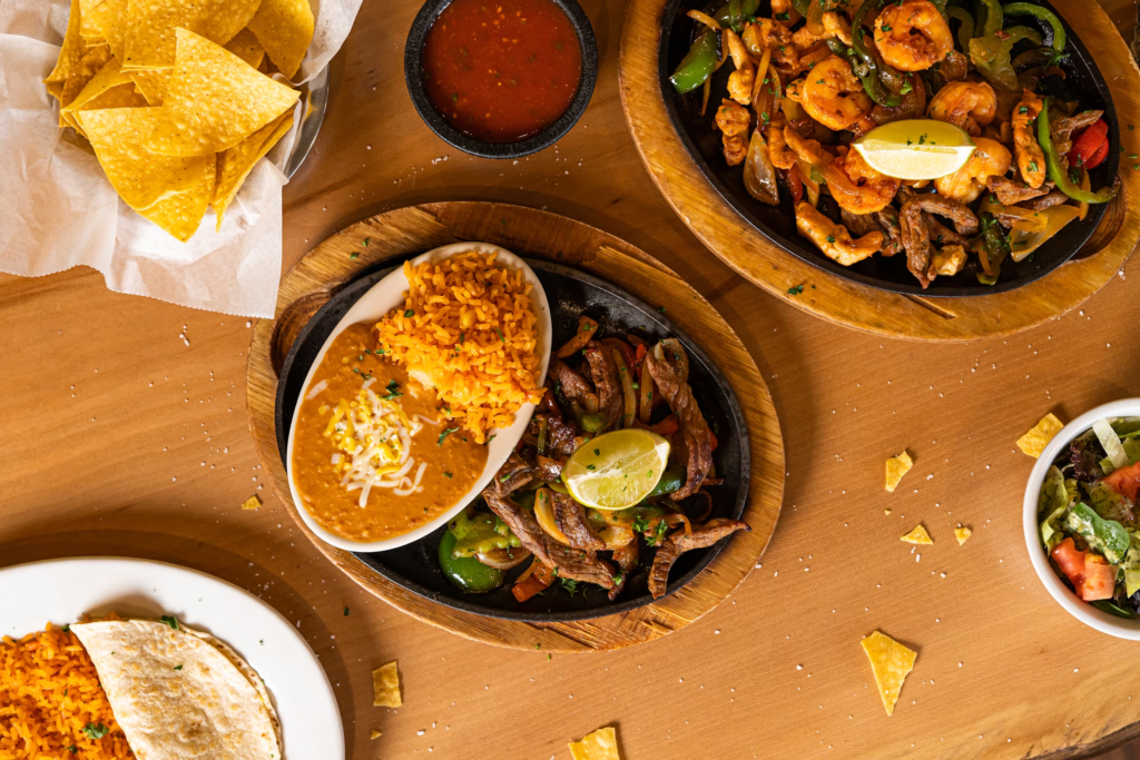 The allure of fajitas lies in their presentation – a sizzling plate accompanied by an array of wraps, salsas, guacamole, sour cream, and cheese.