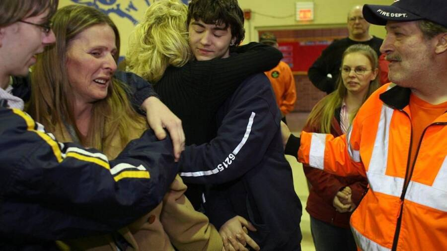 Shawn Hornbeck hugs his family after being rescued from the home of Michael Devlin.