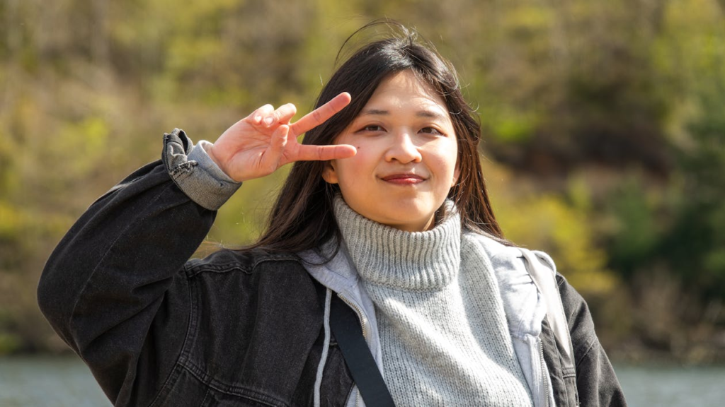 Portrait of Woman Showing V Sign