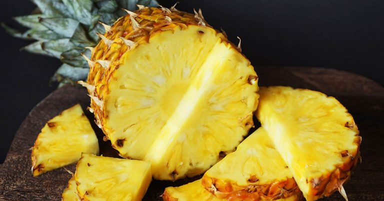 A woman plants pineapples on a baking sheet - Featured image