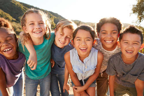 Portrait Of Multi-Cultural Children Hanging Out With Friends In The Countryside Together