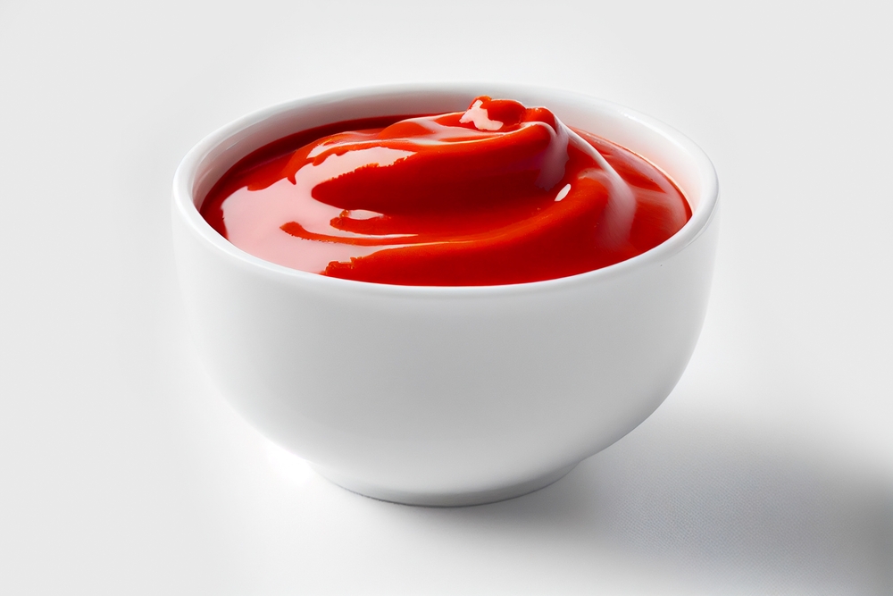 Delicious ketchup in white bowl isolated on white background. Portion of tomato sauce with clipping path. Collection of various sauces