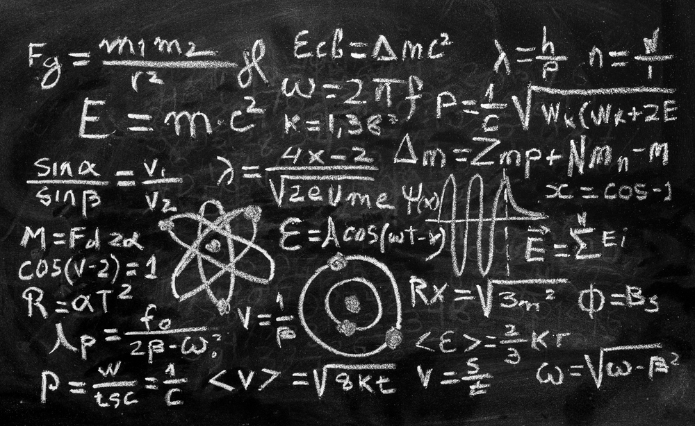 Operations and formulas of quantum physics handwritten with a chalk on the blackboard