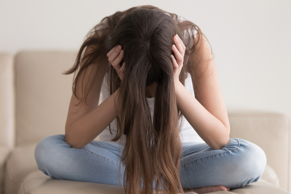 Depressed teenager sitting holding head in hands, stressed sad young woman having mental problems, feeling bad, need psychological help, addicted heartbroken girl experiencing adolescence crisis