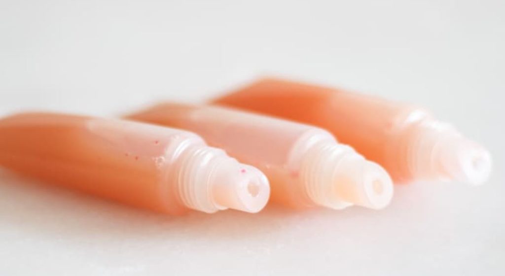 Three tubes of DIY lipgloss. White background.