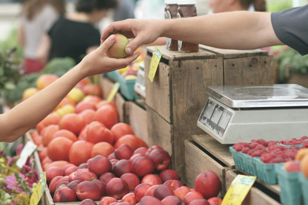 person buying fruit at trader joe's