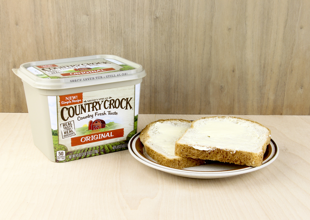 SPENCER , WISCONSIN, February,1,, 2016 Container of Country Crock Vegetable Oil Spread and buttered bread Country Crock is owned by the Unilever Company
