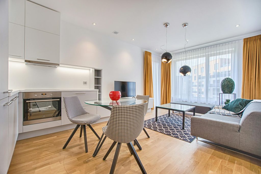 white living room with table and wooden floors
