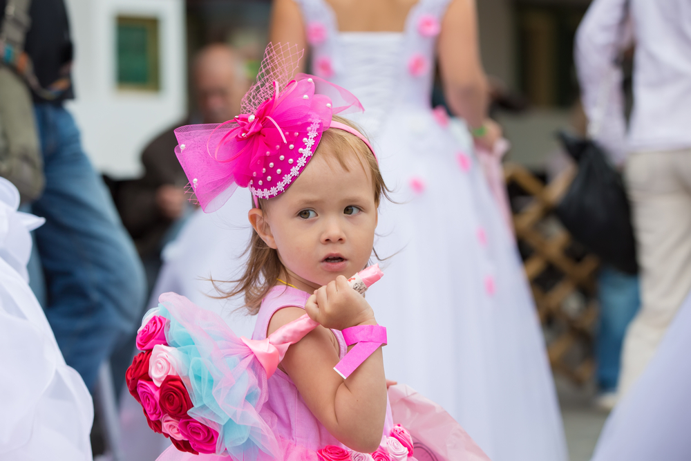Russia. Moscow, August 27, 2017. Imailovsky park.Brides parade. Funny little girl in with a bouquet of flowers at a wedding.