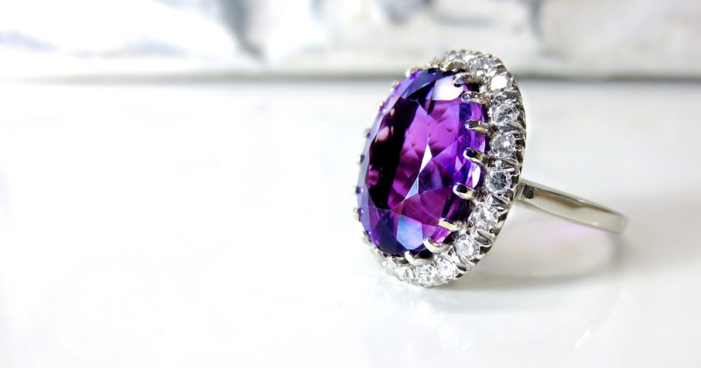 A purple ring with diamonds. White background.