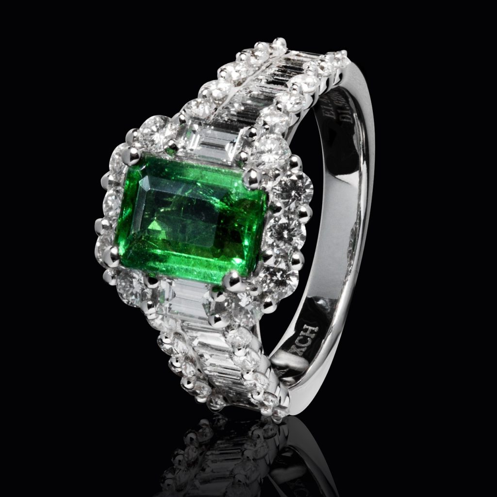 Emerald ring with diamonds. Black background.