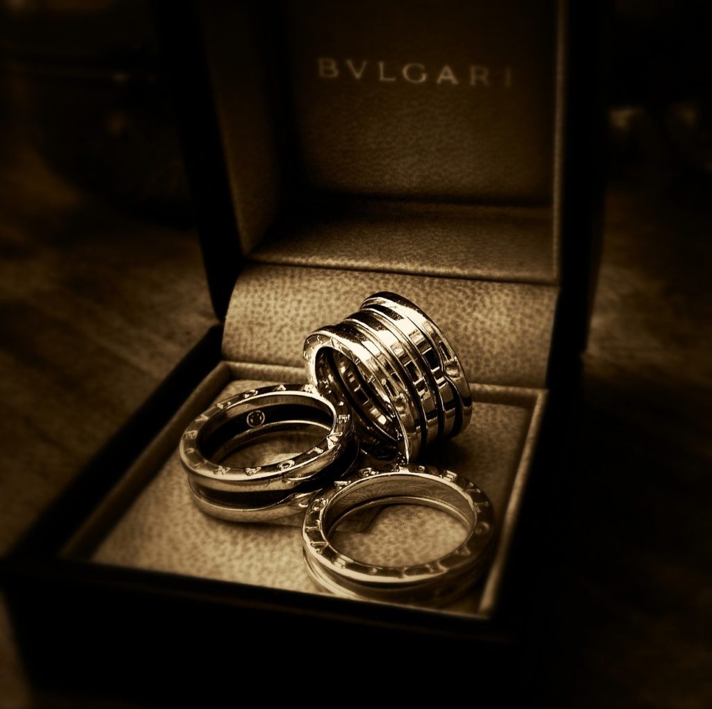 Stackable rings in a jewelry box. Wooden table in the background.