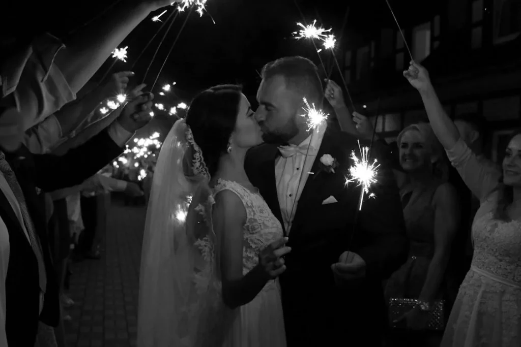 couple getting married holding lit sparklers