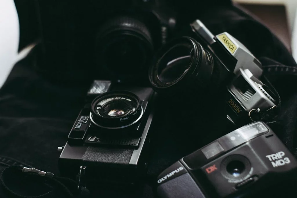 a stack of 3 digital cameras