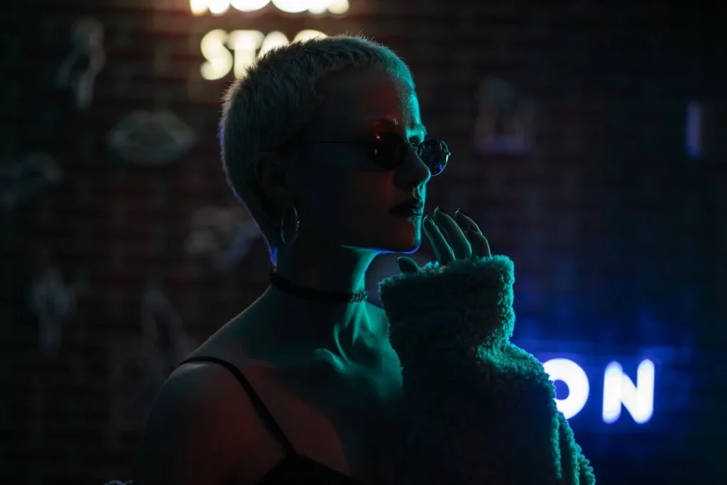 a woman backlit by neon signs