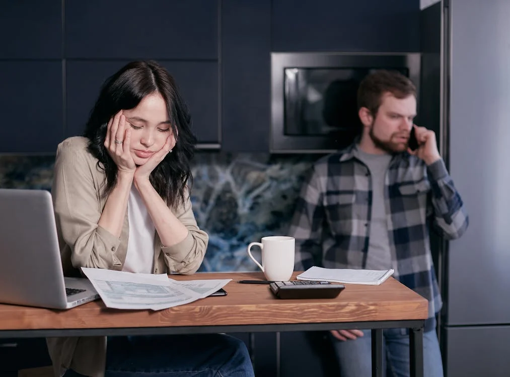 distressed looking couple sitting together