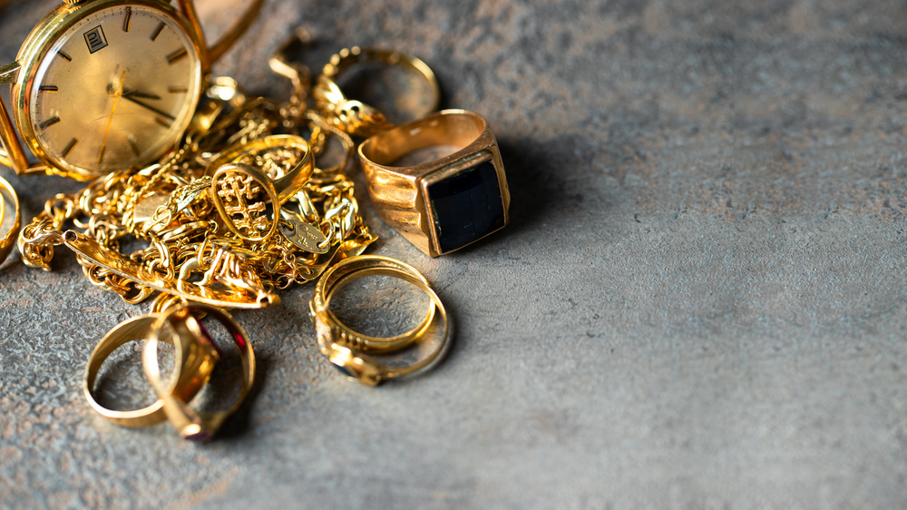 Old and broken jewelry, vintage watches on dark background. Sell gold for cash concept.