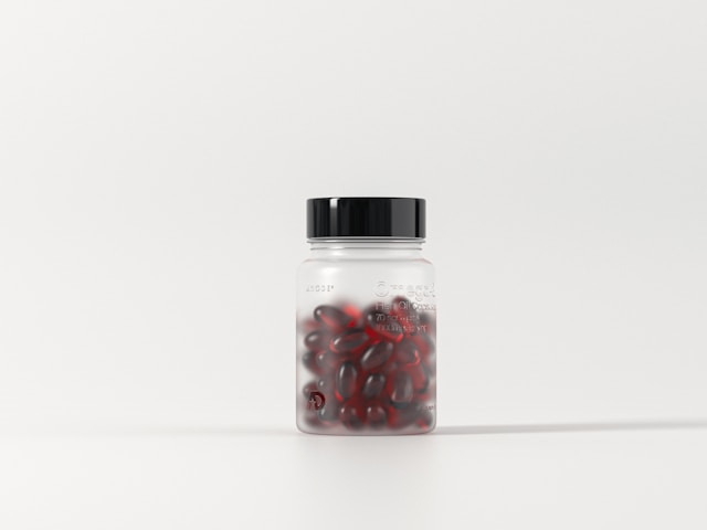 medicine bottle containing red pills