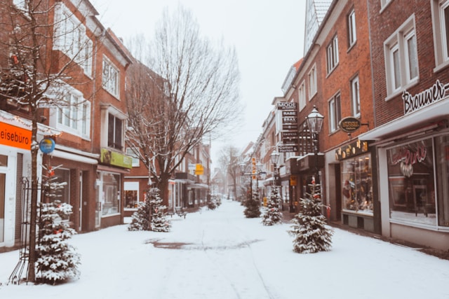 snow-filled path between shops