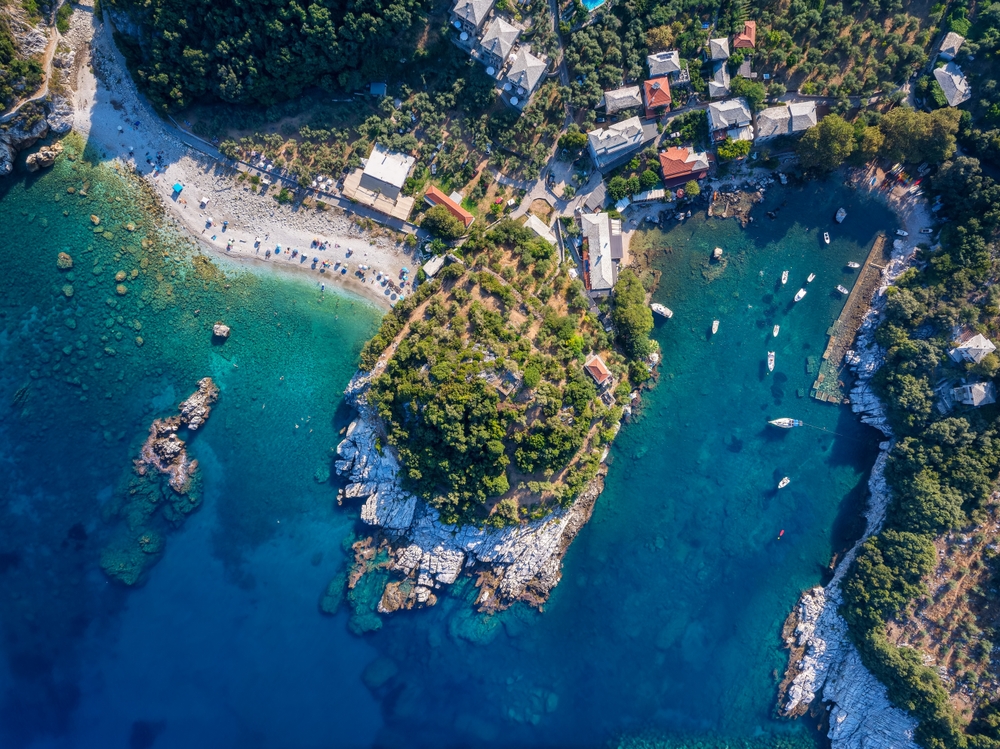 Aerial top down view of the idyllic fishing village of Damouhari with connected beach, North Pelion, Greece