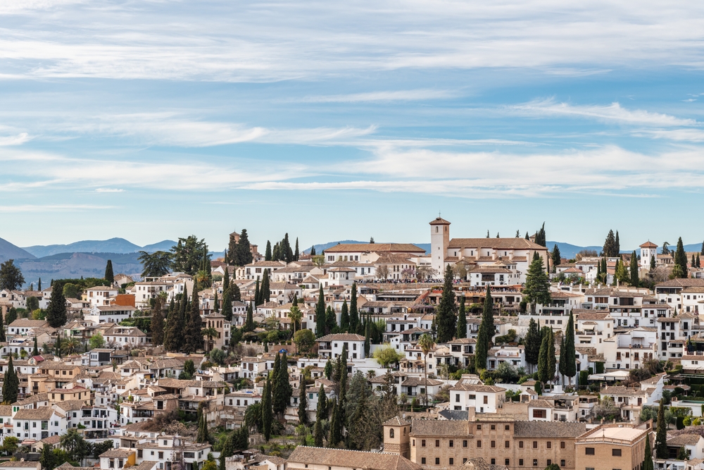 GRANADA, SPAIN: MARCH 24, 2023: Aerial view of the Albaicin in Granada, one of the oldest districts in the city, with its historic monuments and traditional houses.
