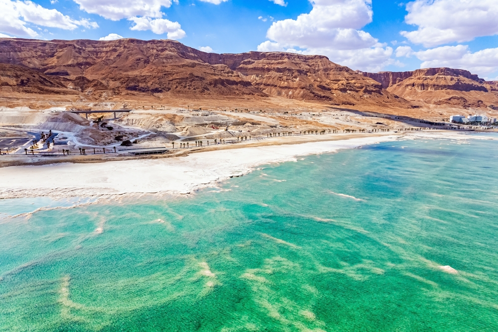 The Dead Sea. Resort for relaxation and treatment. Israel. Cloud shadows reflected in the water. The evaporated salt is collected on the water. Drone filming.
