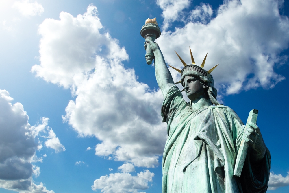 Statue of liberty. Monument in USA. Statue of liberty in New York. Monument from USA under blue sky. Symbol of democracy of united states. Top of statue of liberty close-up. Sights of New York
