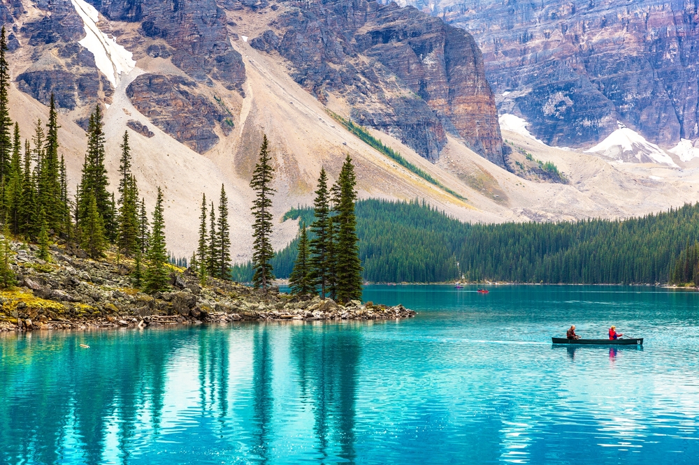 LAKE MORAINE, CANADA - APRIL 2, 2020: Tourists Canoeing on Lake Moraine, Banff National Park Of Canada
