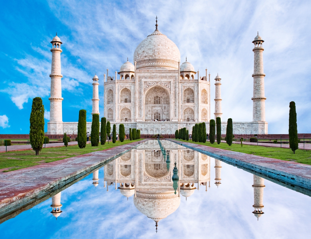 Amazing view on the Taj Mahal with reflection in water. The Taj Mahal is an ivory-white marble mausoleum on the south bank of the Yamuna river. Agra, Uttar Pradesh, India.