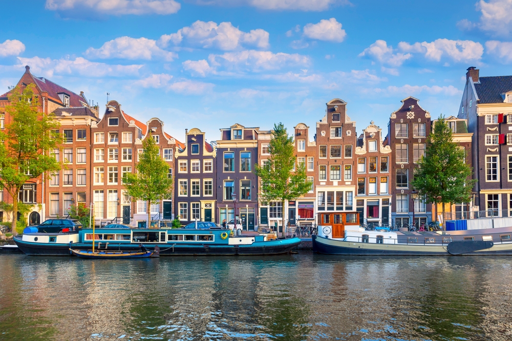 Amsterdam. Panoramic view of the historic city center of Amsterdam. Traditional houses and bridges of Amsterdam. An early quiet morning . Europe, Netherlands, Holland, Amsterdam.