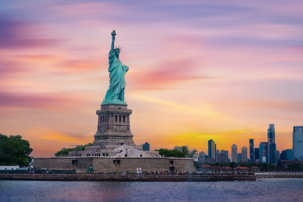 Statue of Liberty at sunset and Manhattan skyline, New York City