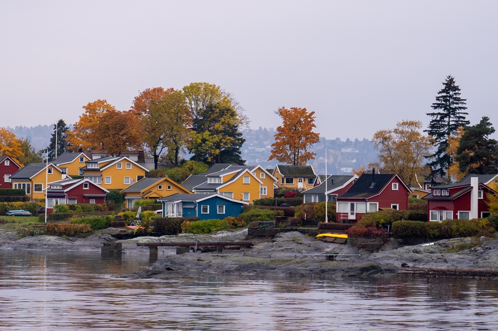 Oslo, Norway - October 20, 2024: Oslofjord (Oslofjorden), view of summer houses and cottages. Frame houses for recreation. Hut among the forest and rocks. Multicolored private houses.